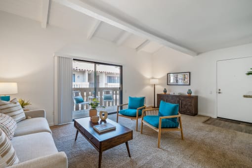 a living room with a couch chairs and a coffee table