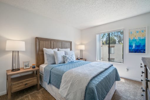 a bedroom with a large bed and a large window