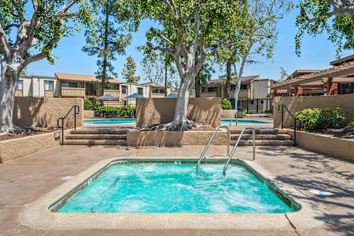 A small pool with a ladder in the middle of it.