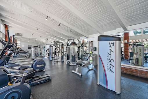 A gym with a variety of equipment and a sign that says "Parkour".