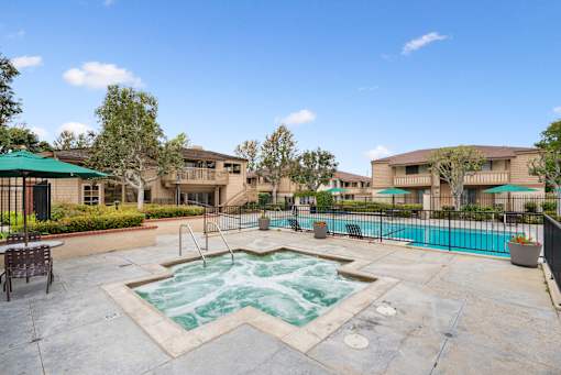 A pool with a hot tub in the middle of it.