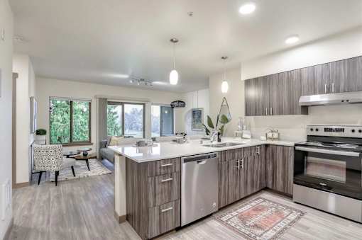 A modern kitchen with a large island and stainless steel appliances.