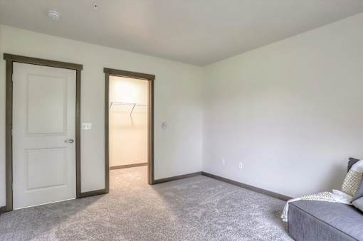 A bedroom with a bed and a couch.