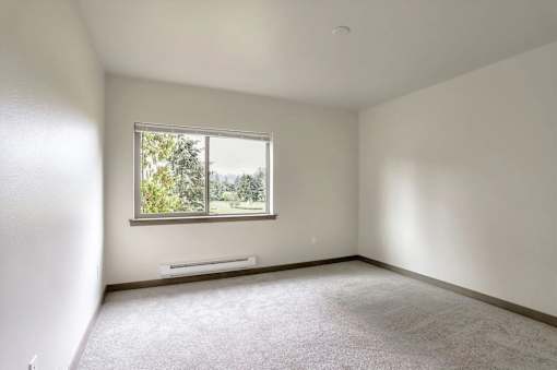A room with a window and a bench.