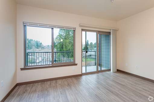 A room with a sliding glass door and a window.