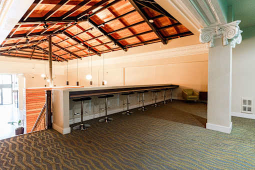 A room with a bar and a carpeted floor.