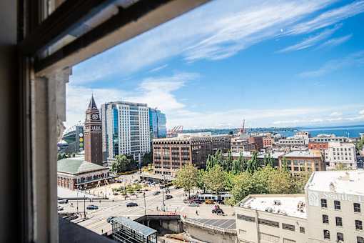 A cityscape with a clock tower and a clear blue sky.