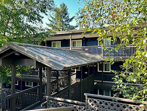 A house with a metal roof and a balcony.