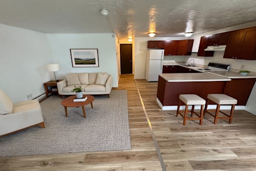 A living room with a couch, chair, and coffee table.