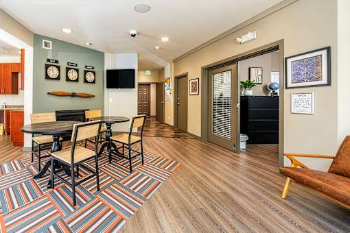 A living room with a fireplace and a dining table.