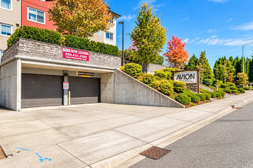 A building with a sign that says "Now Hiring" on it.