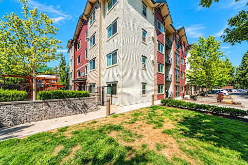 A multi-story apartment building with a red and beige exterior.