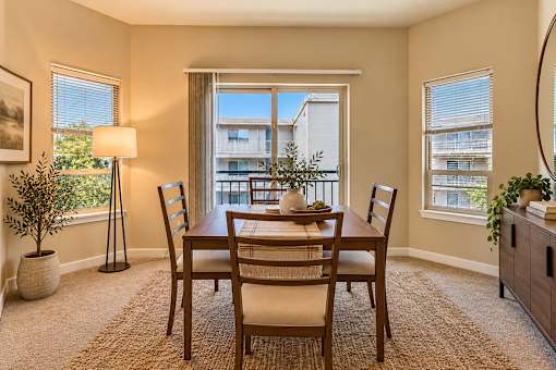 A dining room with a table set for four.