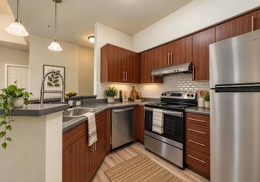 A modern kitchen with wooden cabinets and stainless steel appliances.