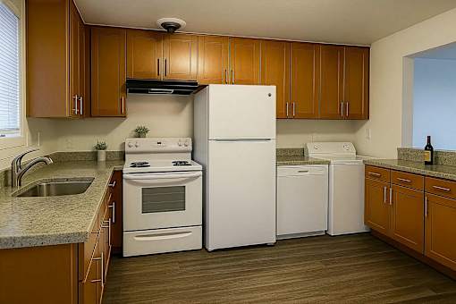 A kitchen with wooden cabinets and white appliances.