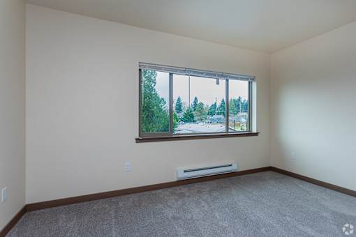 A room with a window overlooking a street.