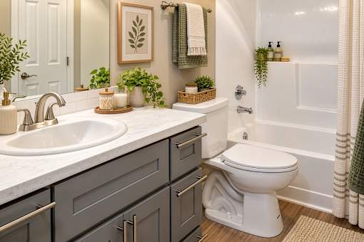 A white toilet sits in a bathroom next to a bathtub.