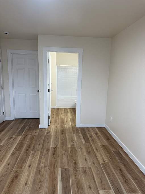 A room with a white door and a white wall.