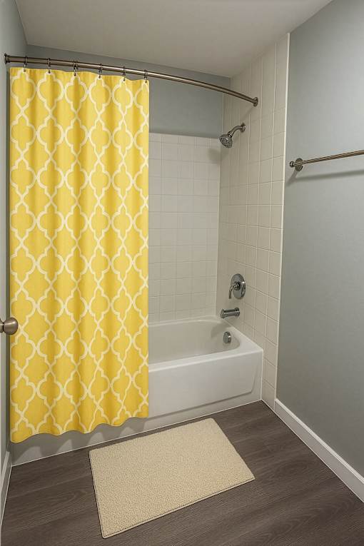 A yellow shower curtain with a diamond pattern hangs in a white bathroom.