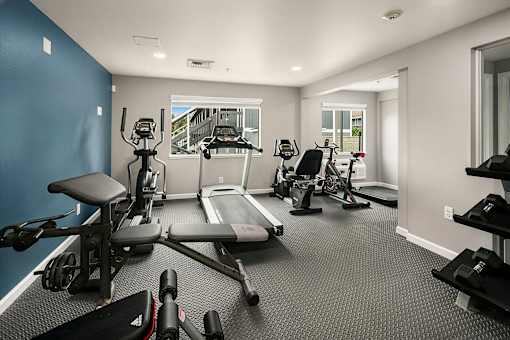 A spacious home gym with a variety of exercise equipment.