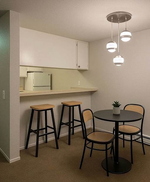 A small table with four chairs around it.
