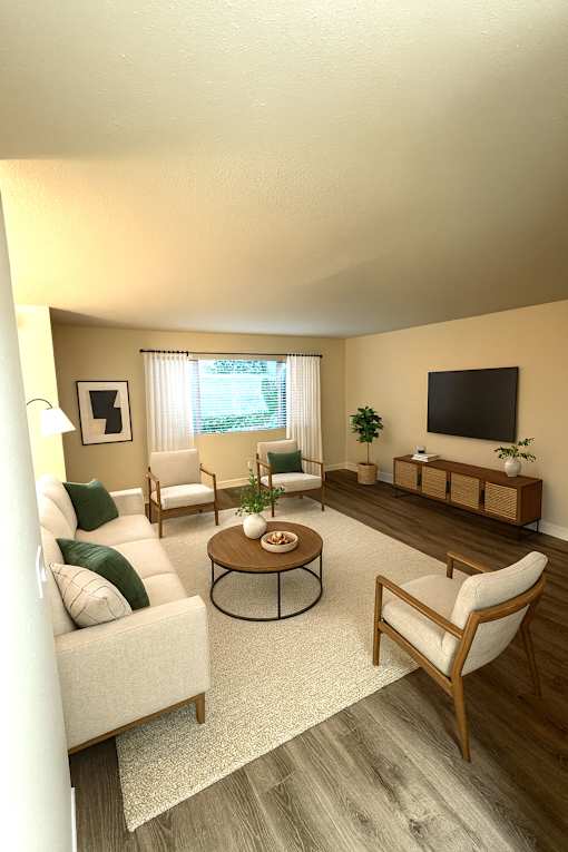 A living room with a white couch, a wooden coffee table, and a flat screen TV mounted on the wall.