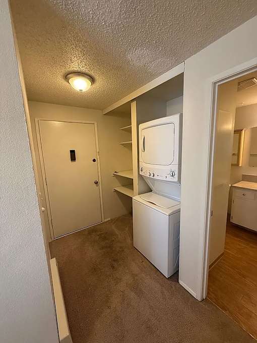 A small laundry room with a washer and dryer.