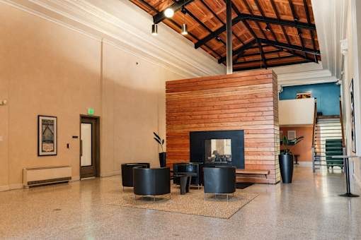 A room with a fireplace and a wooden wall.