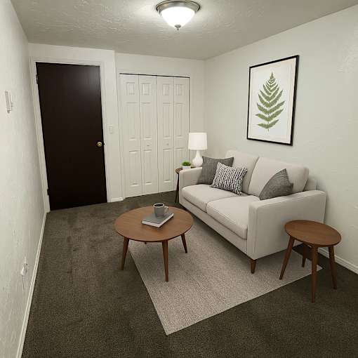 A living room with a couch, coffee table, and lamp.