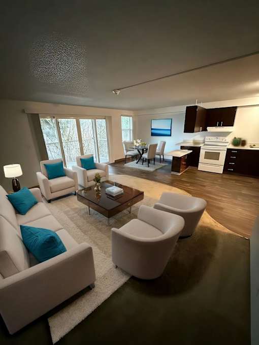 A modern living room with a white sofa and a glass coffee table.