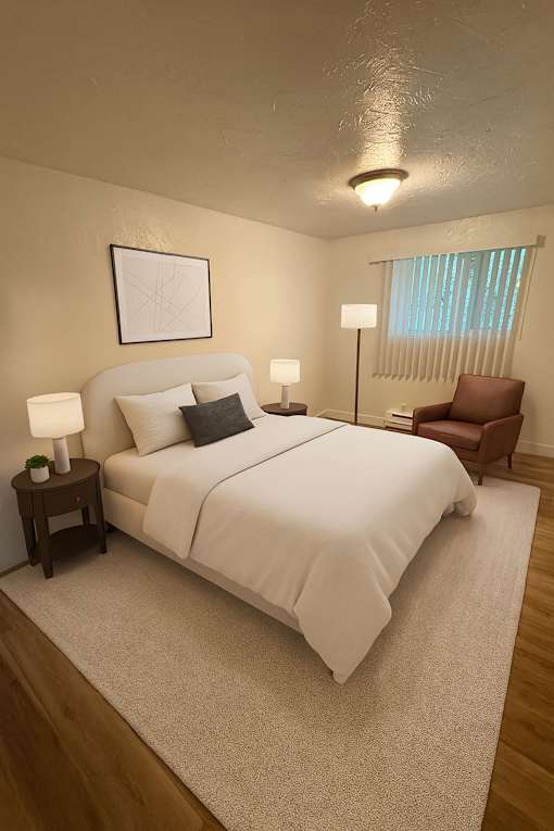 A bedroom with a bed, chair, and two lamps.