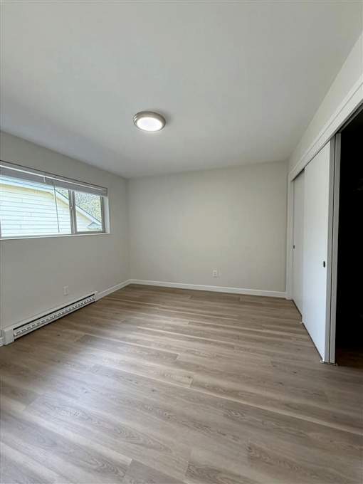 A room with a window and a door.