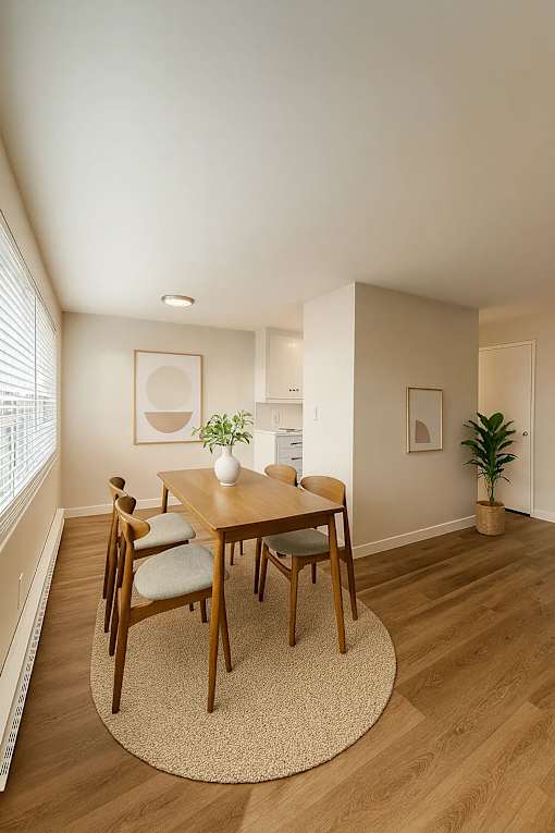 A dining room with a wooden table and chairs.