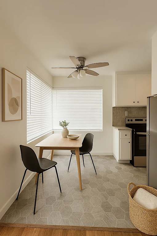 A small dining room with a table and chairs.
