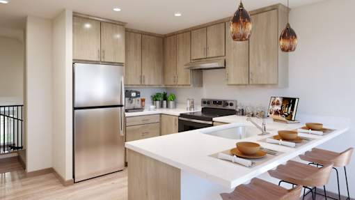 A modern kitchen with a stainless steel refrigerator and wooden cabinets.