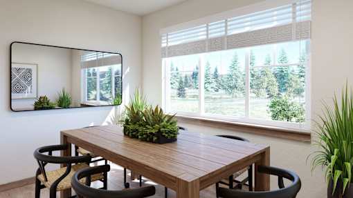 A wooden table with four chairs and a potted plant sits in front of a window with a view of trees outside.