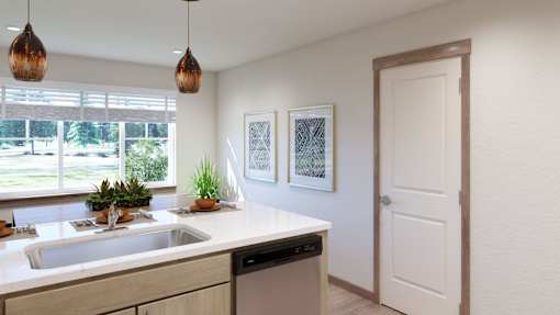 A kitchen with a white counter top and a white sink.