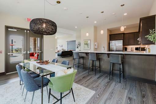 A modern kitchen with a dining table and chairs.
