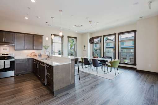 A modern kitchen with dark wood floors and a large island.