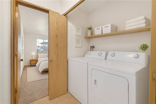 A small laundry room with a washer and dryer.