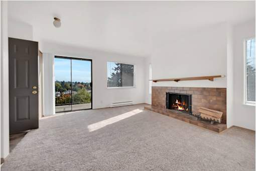 A room with a fireplace and a sliding glass door.