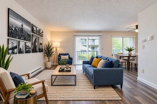 A living room with a blue couch and a coffee table.