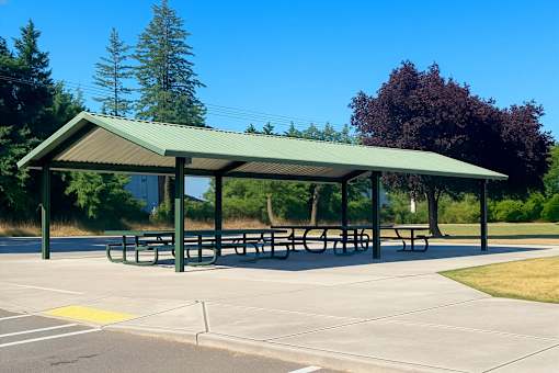 A covered picnic area with tables and benches.