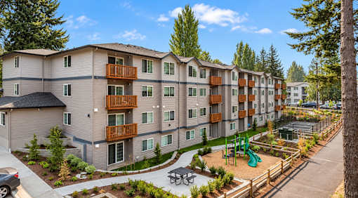 Apartment complex with a playground in the front.