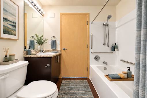 A bathroom with a toilet, sink, and bathtub.
