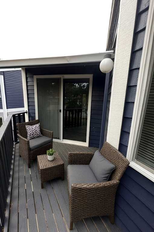 A small balcony with a sofa and a table.