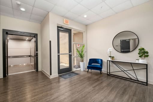 a room with a blue chair and a mirror in it