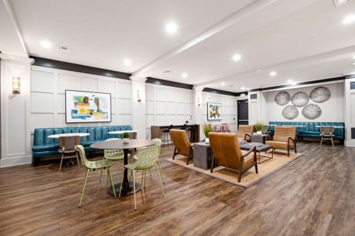 a seating area with tables and chairs in a lobby