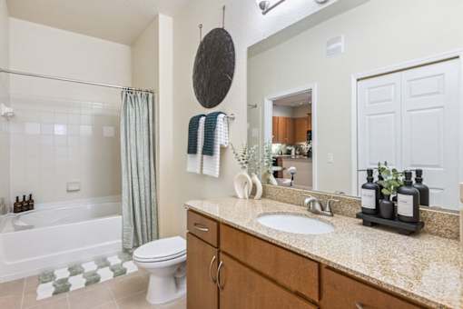 A bathroom with a white toilet, a sink, and a bathtub.