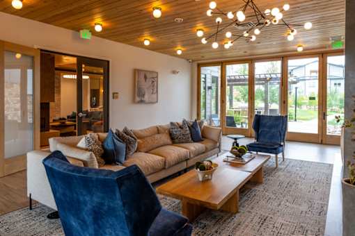 A living room with a couch, chairs, and a coffee table.